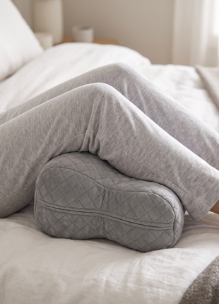 Close detail of the Side Sleeper Leg Pillow supporting the knees in use